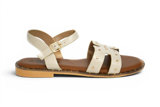 sandalia de mujer en color beige y tachuelas doradas con agarre al tobillo con hebilla y suela plana de talla 38 hasta la 43